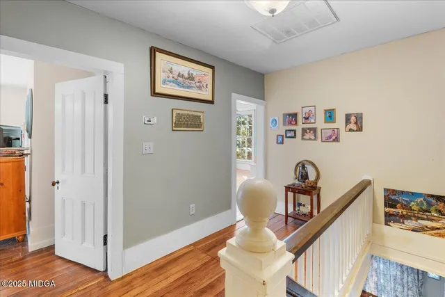 a bedroom with a bed window and a flat screen tv