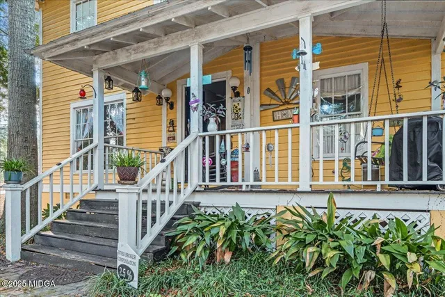 a view of a house with large windows and stairs