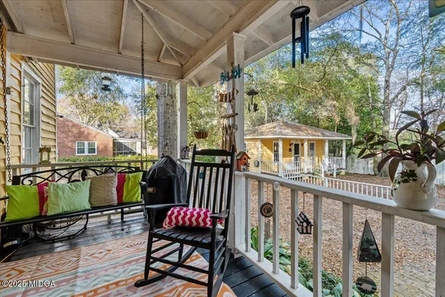 a view of a chairs and table in the balcony