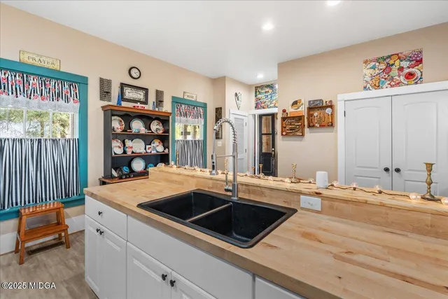 a kitchen that has a lot of cabinets a sink and a stove