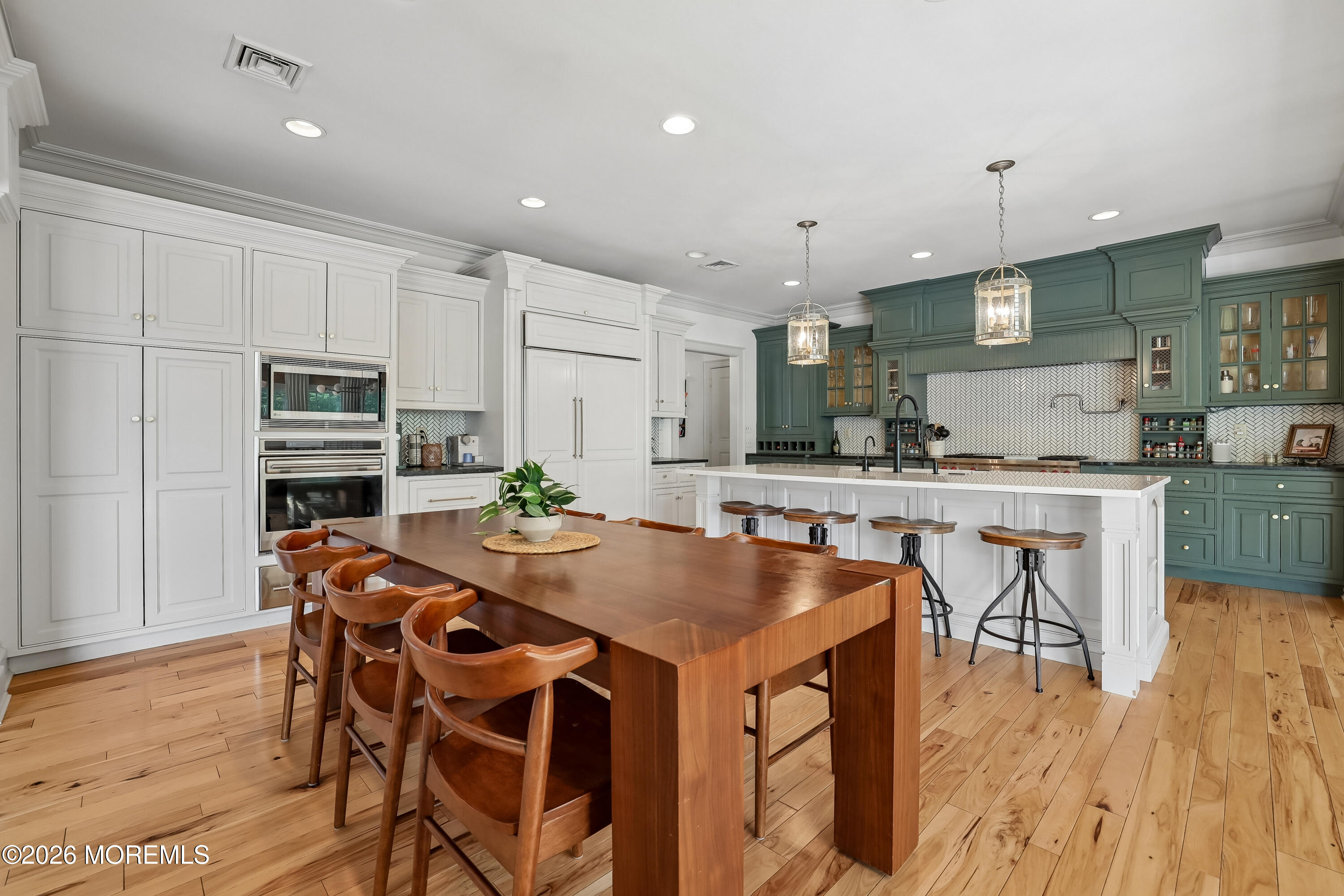 92 Tulip Lane Colts Neck, NJ 07722 - Photo 12 of 55 a kitchen with stainless steel appliances kitchen island granite countertop a kitchen island and chairs in it