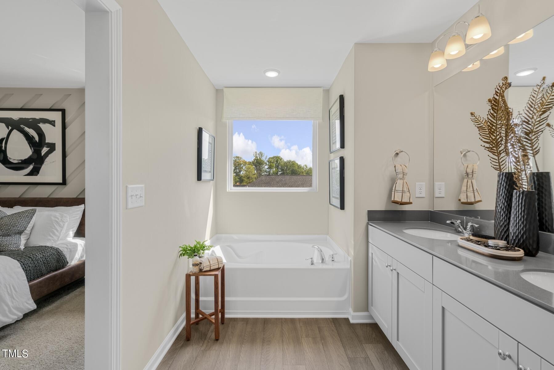164 Siebold Street Garner, NC 27529 - Photo 30 of 70 a bathroom with a sink a bathtub and a window