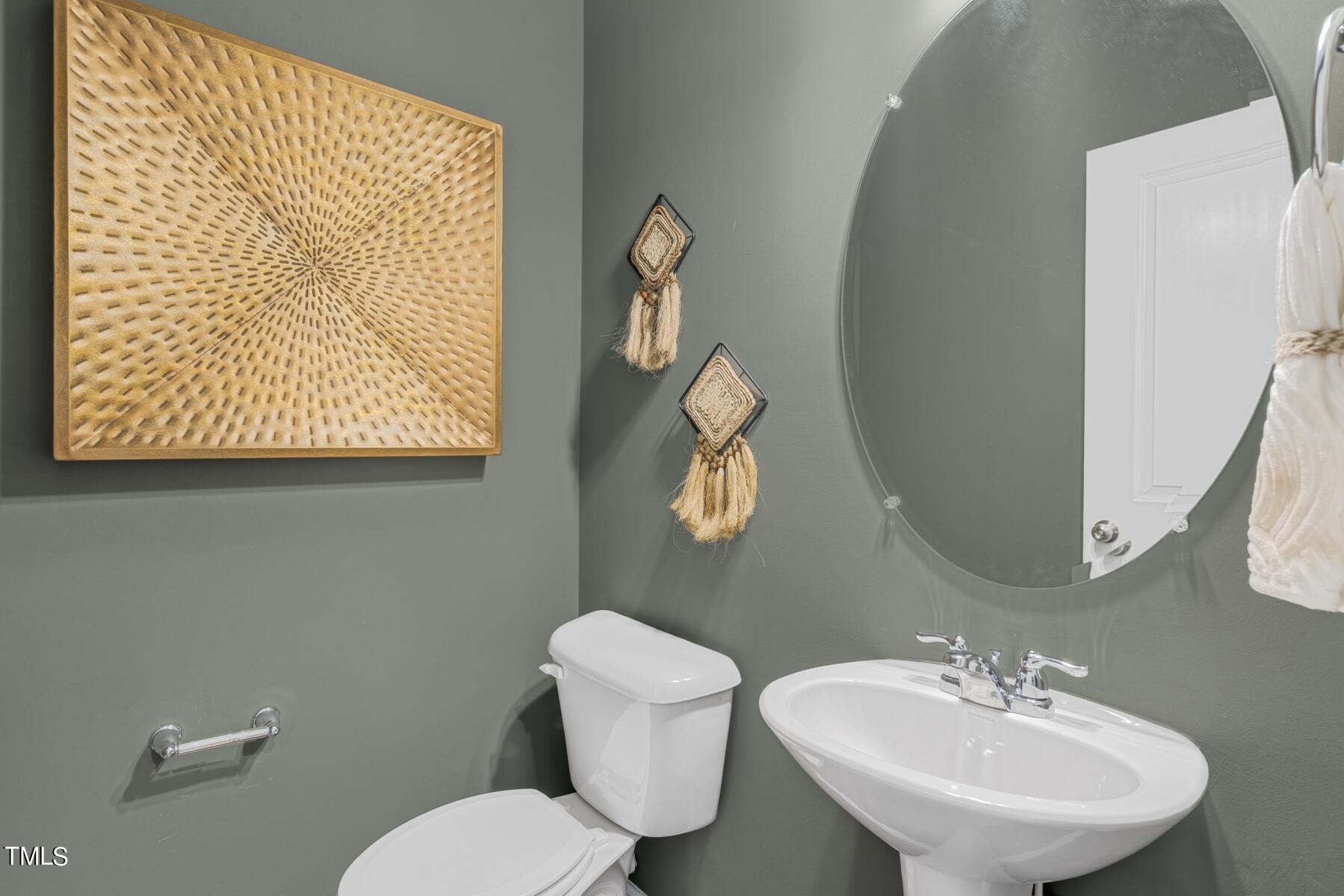 164 Siebold Street Garner, NC 27529 - Photo 39 of 70 a bathroom with a toilet a sink and mirror