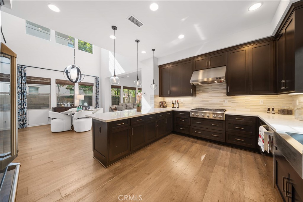105 Newall Irvine, CA 92618 - Photo 12 of 59 a large kitchen with stainless steel appliances and a large counter top