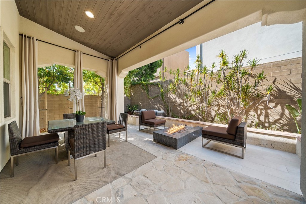 105 Newall Irvine, CA 92618 - Photo 18 of 59 a living room with furniture and a floor to ceiling window