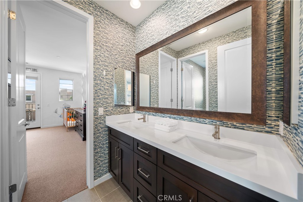 105 Newall Irvine, CA 92618 - Photo 38 of 59 a bathroom with a sink double vanity and a mirror