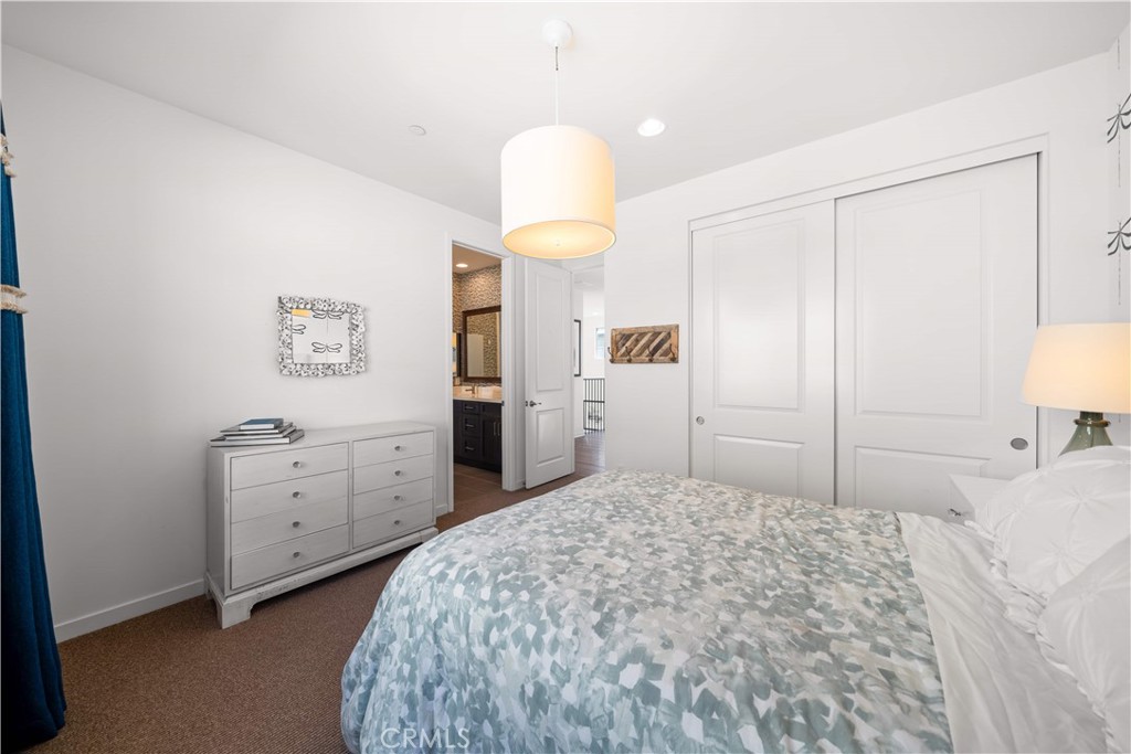 105 Newall Irvine, CA 92618 - Photo 41 of 59 a bedroom with a bed and a chandelier