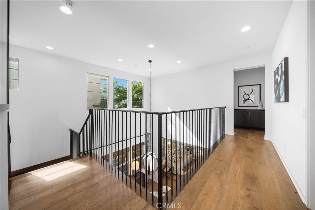 105 Newall Irvine, CA 92618 - Photo 43 of 59 a view of a hallway with wooden floor and windows