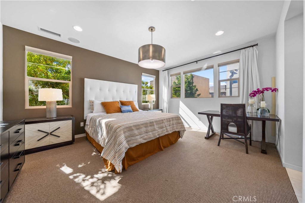 105 Newall Irvine, CA 92618 - Photo 44 of 59 a bedroom with a bed and a chandelier