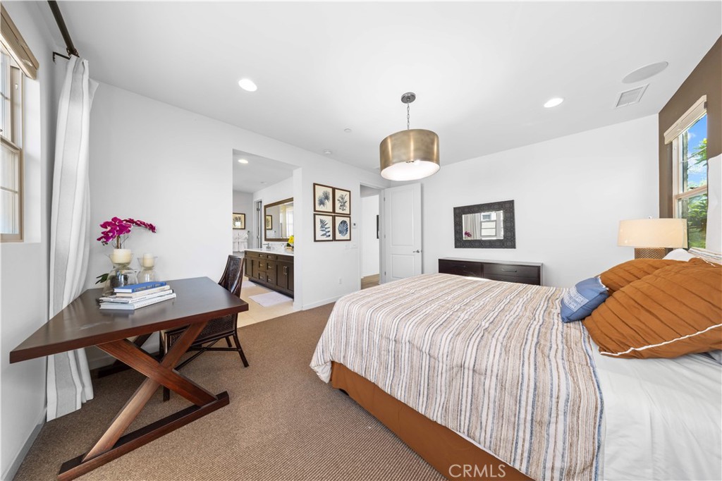 105 Newall Irvine, CA 92618 - Photo 45 of 59 a bedroom with a bed and a table in it