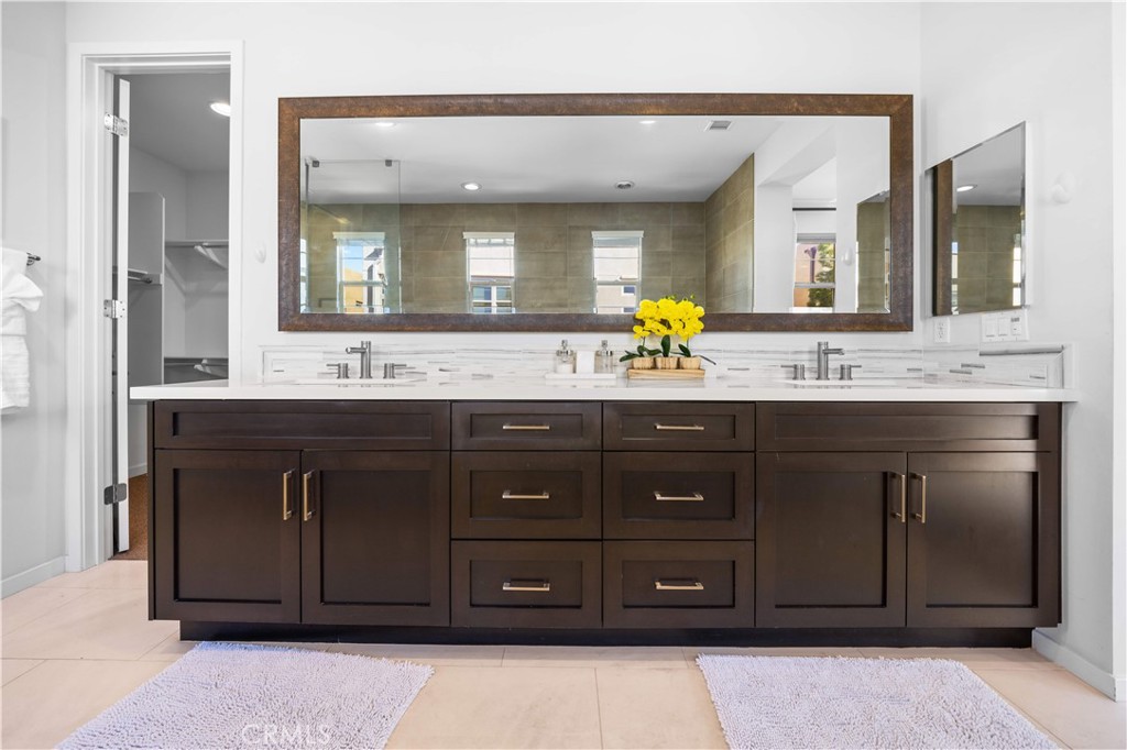 105 Newall Irvine, CA 92618 - Photo 48 of 59 a bathroom with a granite countertop sink and a mirror
