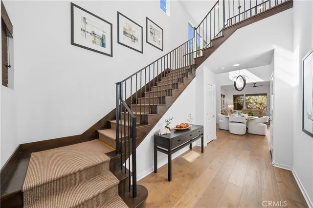 a view of entryway and hall with wooden floor