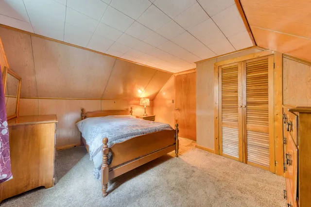 a bedroom with a bed and dresser