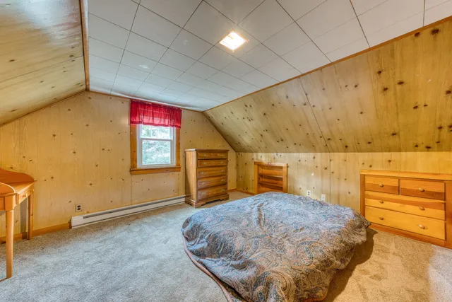 a front view of a house with a yard and potted plants