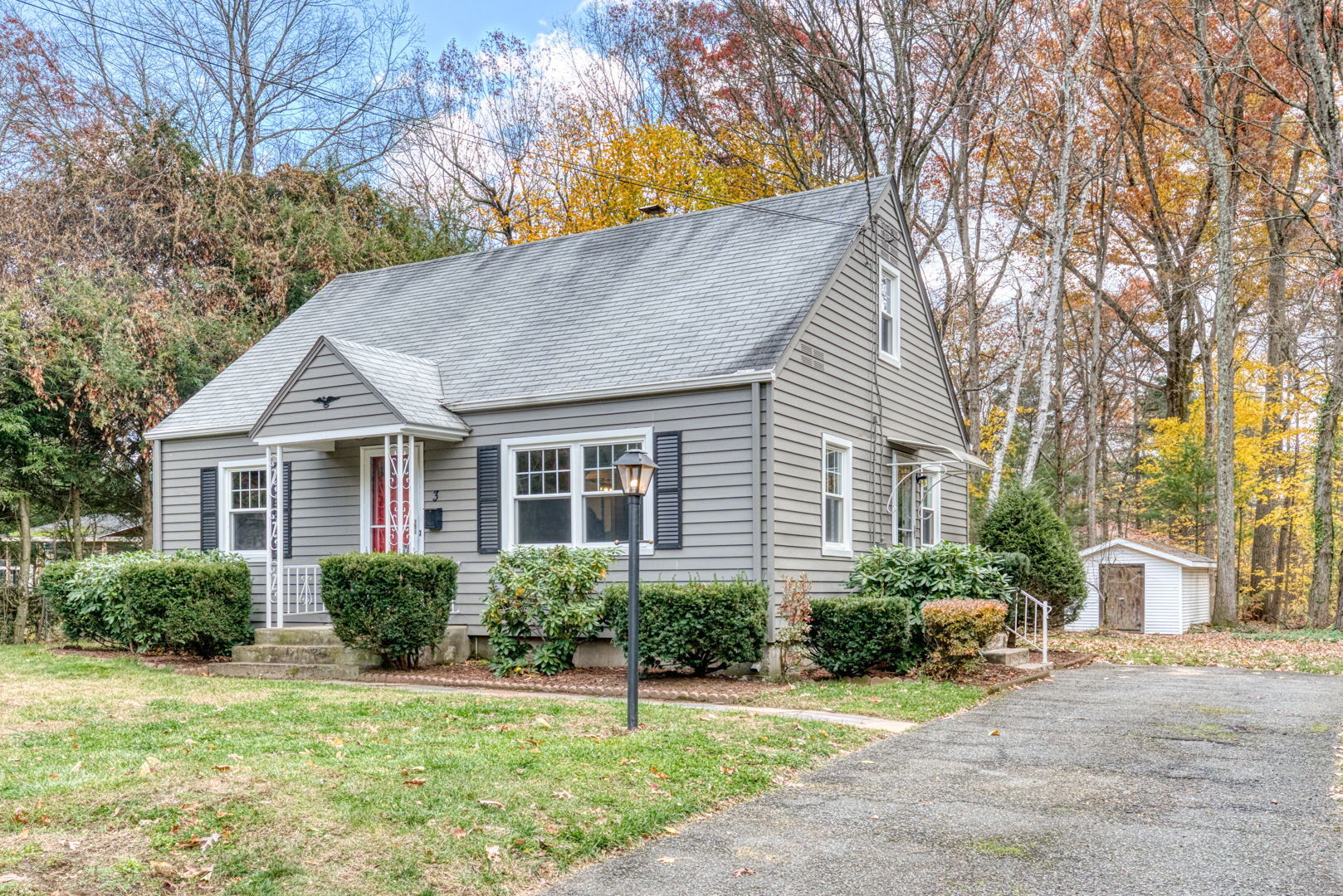 3 Avon St Extension Enfield, CT 06082 - Photo 15 of 16 a front view of a house with a yard and potted plants