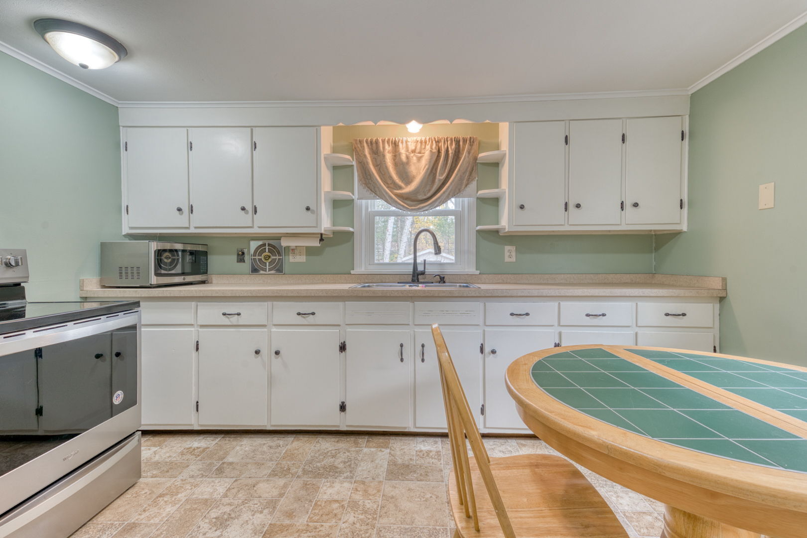 3 Avon St Extension Enfield, CT 06082 - Photo 10 of 16 a kitchen with granite countertop white cabinets and white appliances