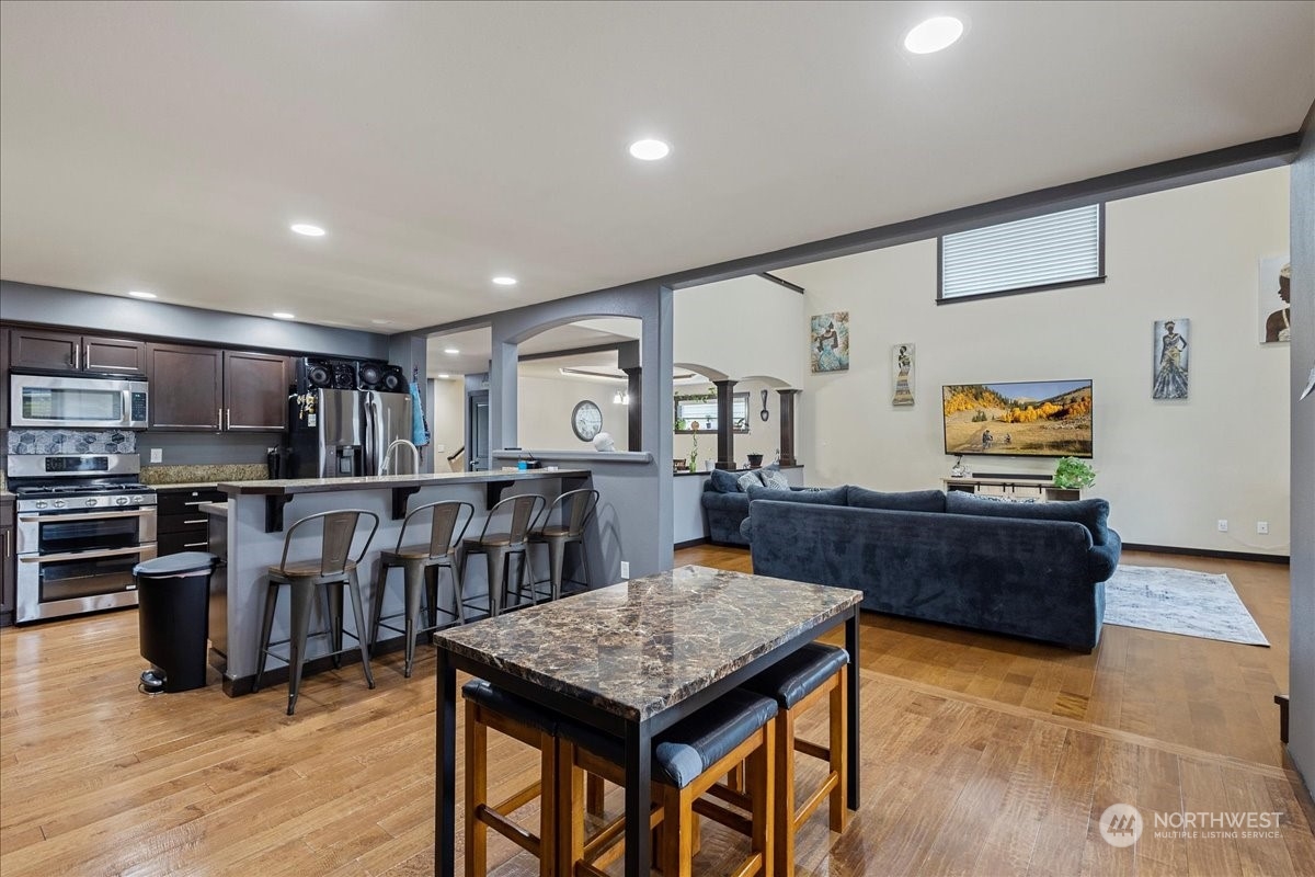 431 Barry Loop Mount Vernon, WA 98274 - Photo 13 of 32 a living room with lots of furniture and kitchen view