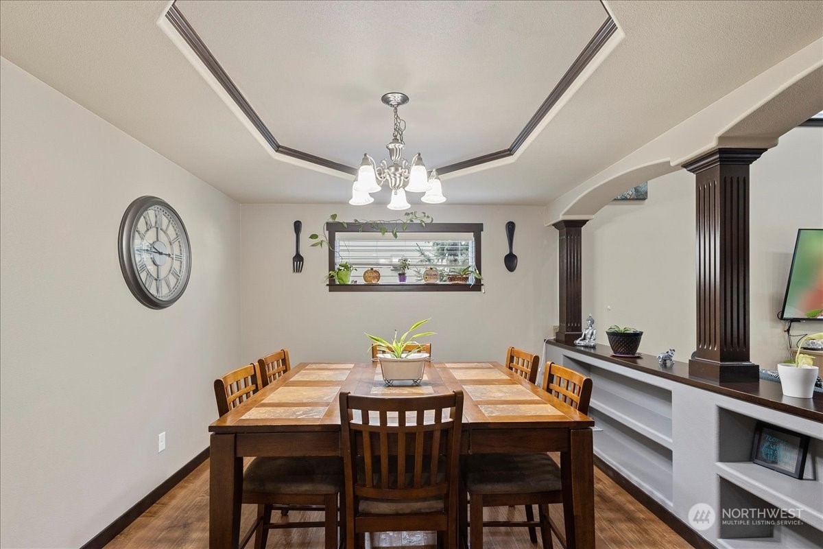 431 Barry Loop Mount Vernon, WA 98274 - Photo 14 of 32 a view of a dining room with furniture a chandelier and wooden floor