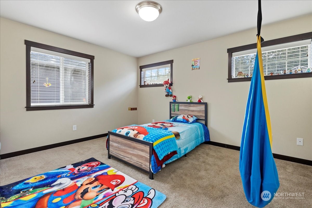431 Barry Loop Mount Vernon, WA 98274 - Photo 23 of 32 a bedroom with bed and a wooden floor
