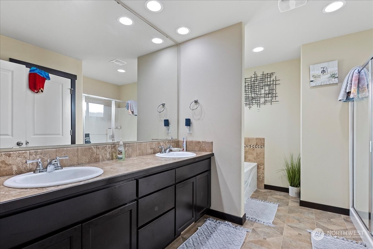 431 Barry Loop Mount Vernon, WA 98274 - Photo 28 of 32 a bathroom with a granite countertop sink a mirror and a shower