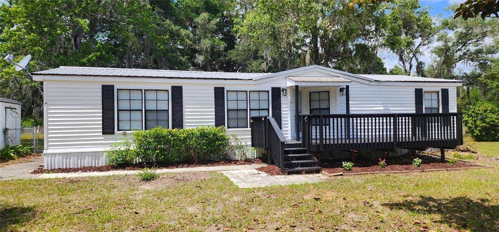 19865 Southwest 5th Place Dunnellon, FL 34431 - Photo 1 of 78 a front view of a house with a yard