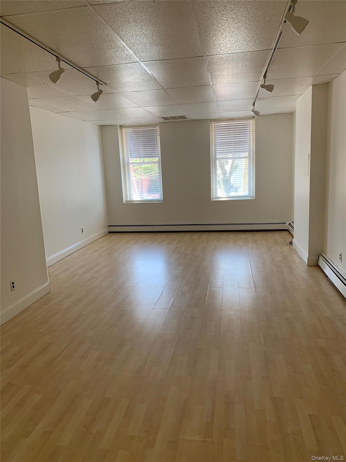 249 Main Street, Unit WEST Huntington, NY 11743 - Photo 4 of 6 an empty room with wooden floor and windows