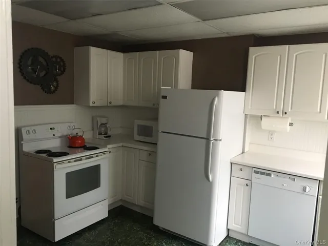 a white refrigerator freezer sitting inside of a kitchen
