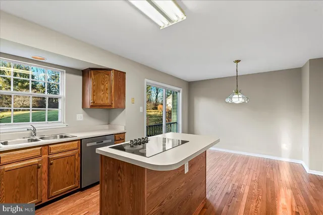 a kitchen with a sink appliances and a window