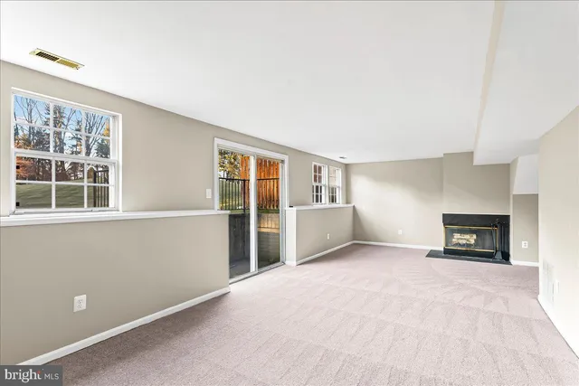 a view of empty room with a fireplace