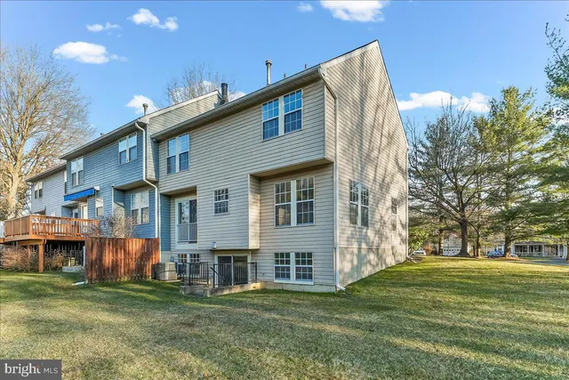 a backyard of a house with barbeque oven and outdoor seating