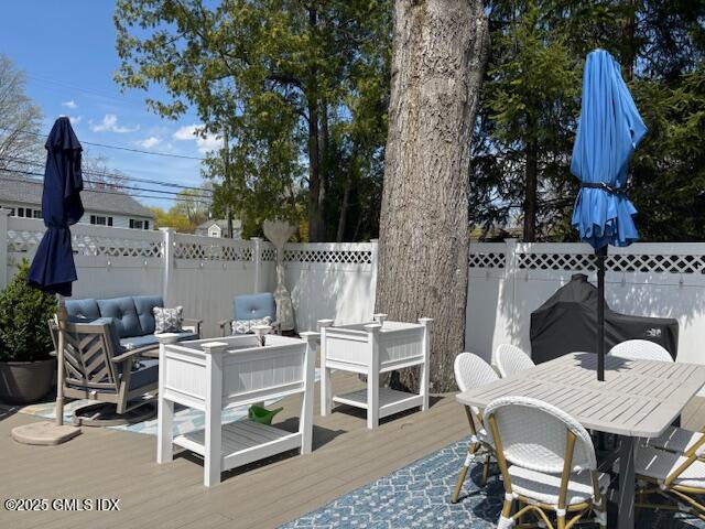 8 Perry Place Riverside, CT 06878 - Photo 19 of 26 a view of a patio with table and chairs with wooden fence and plants