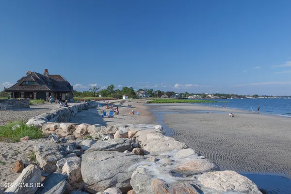 a view of a lake with lawn chairs