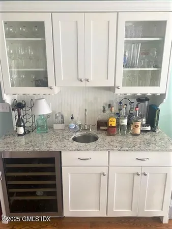 a kitchen with granite countertop a sink cabinets and window