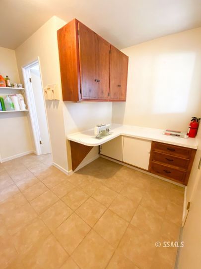 516 West Wasp Avenue Ridgecrest, CA 93555 - Photo 7 of 25 a view of a kitchen with a sink and a refrigerator