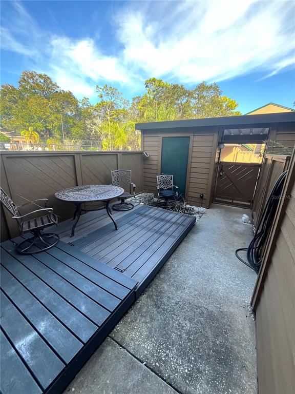 1805 Lennox Road East, Unit 1805 Palm Harbor, FL 34683 - Photo 14 of 15 a roof deck with table and chairs