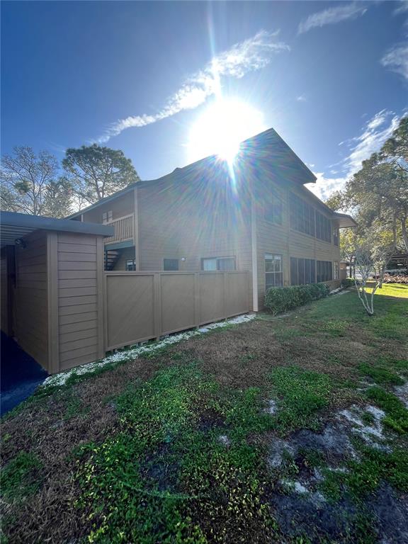 1805 Lennox Road East, Unit 1805 Palm Harbor, FL 34683 - Photo 15 of 15 a backyard of a house with lots of green space