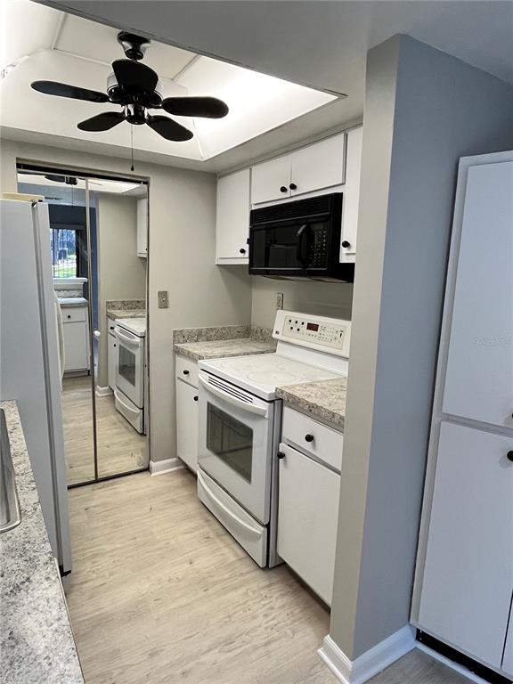 1805 Lennox Road East, Unit 1805 Palm Harbor, FL 34683 - Photo 6 of 15 a kitchen with a stove and a microwave