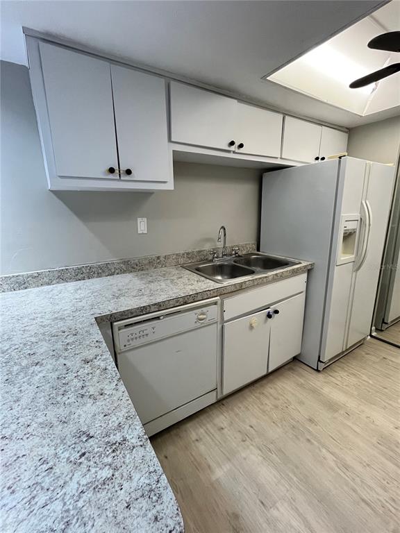 1805 Lennox Road East, Unit 1805 Palm Harbor, FL 34683 - Photo 7 of 15 a kitchen with stainless steel appliances granite countertop a sink a stove and a refrigerator