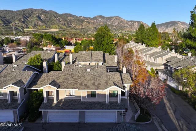 a view of houses with a street