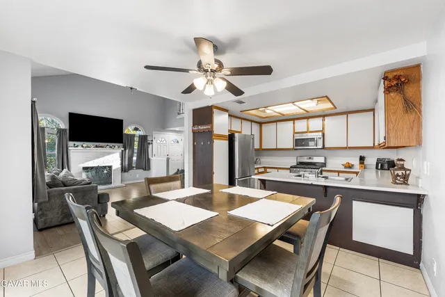 a kitchen with a dining table and chairs