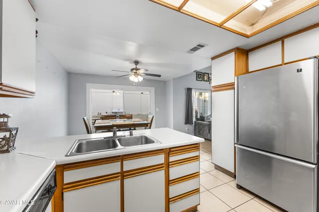 a kitchen with stainless steel appliances a refrigerator and a stove