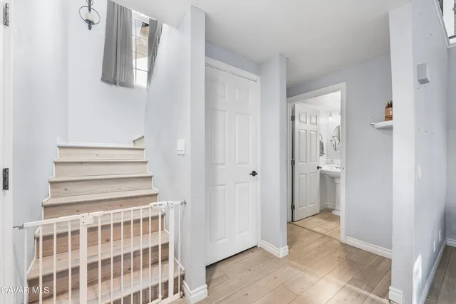 a view of a hallway with wooden floor and entryway