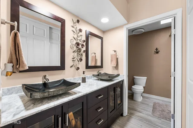 a bathroom with a double vanity sink and a mirror