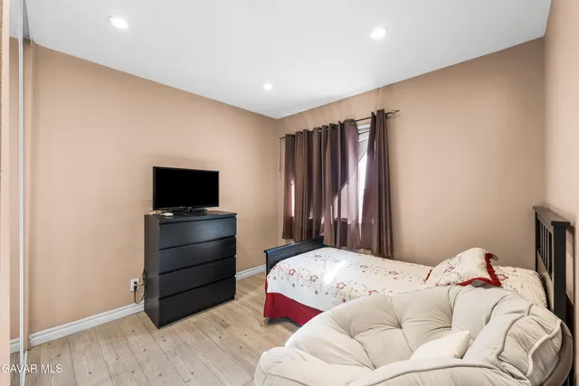 a bedroom with a bed and a television