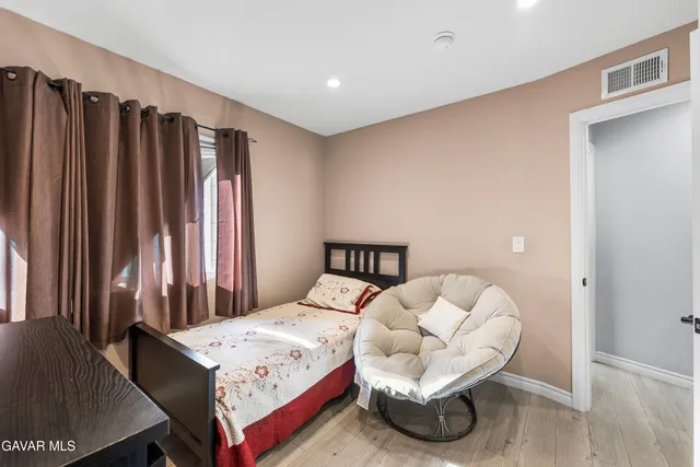 a bedroom with a bed and a large mirror