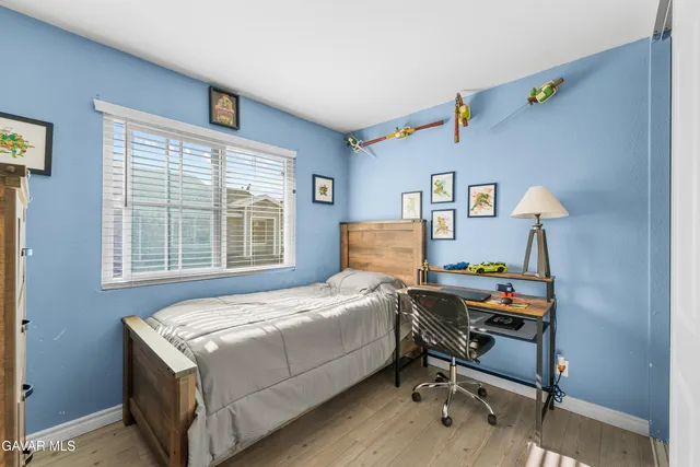 a bed room with a bed and a desk