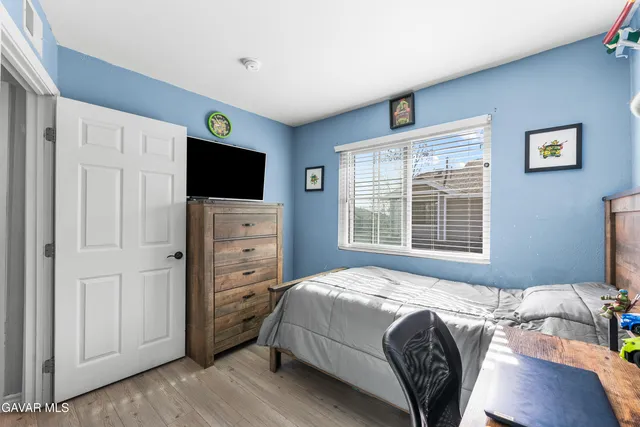 a bedroom with a bed and a flat screen tv