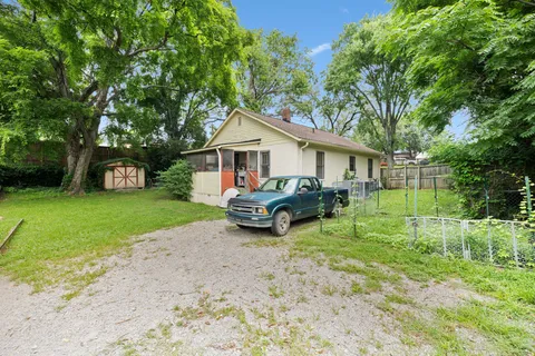 a view of a house with a yard and sitting area