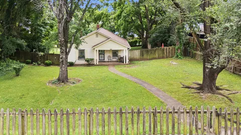 a front view of a house with yard and green space