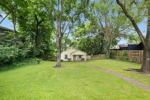 a yellow house in middle of the forest
